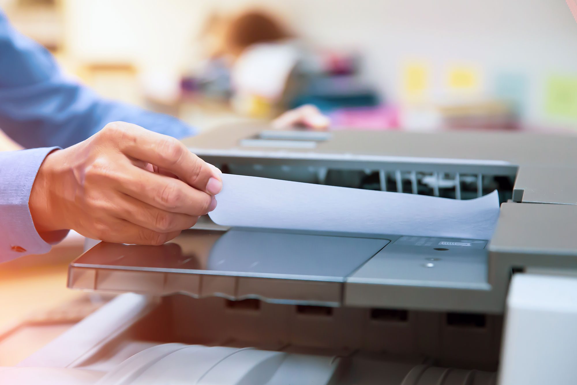 Man scanning in documents to a scanner